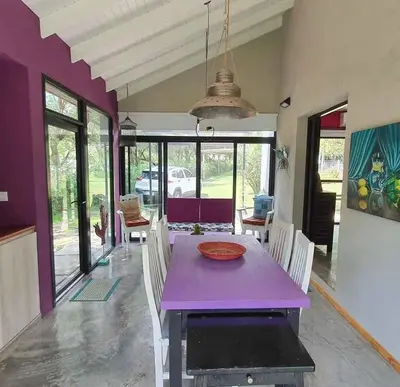 a dining room with a purple table and chairs at ASM CASA I in Merlo