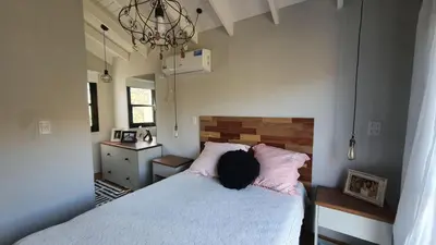 a person sitting on a bed in a bedroom at ASM CASA I in Merlo