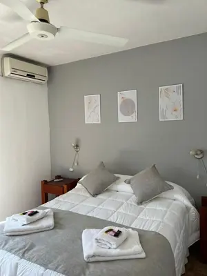 two beds in a bedroom with towels on them at HOTEL OLIVIA in Mina Clavero