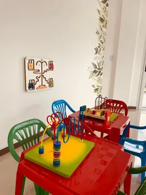 a dining room with a table and colorful chairs at Departamento frente al lago en Villa Carlos Paz in Villa Carlos Paz