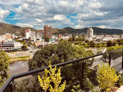 a view of a city from a balcony at Departamento frente al lago en Villa Carlos Paz in Villa Carlos Paz