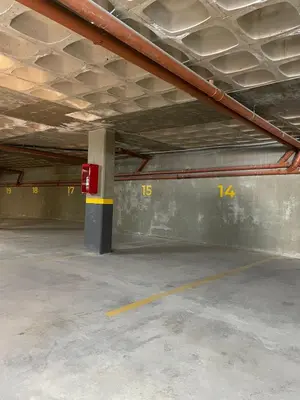 an empty parking garage with a red and yellow pole at Departamento frente al lago en Villa Carlos Paz in Villa Carlos Paz