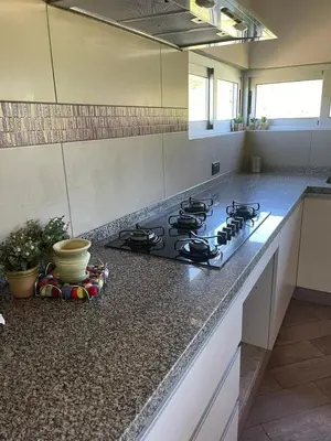 a kitchen with a stove and a counter top at Casa Sierras de Córdoba Villa el Diquecito in La Calera