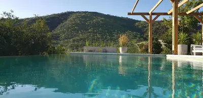a swimming pool with a mountain in the background at Casa Sierras de Córdoba Villa el Diquecito in La Calera