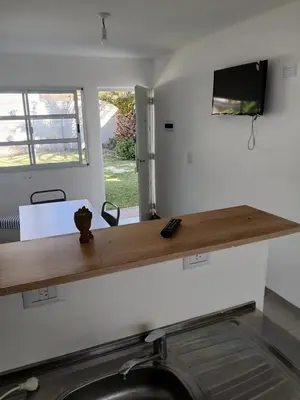 a kitchen with a wooden counter top on the wall at La casa de Clo in Villa Carlos Paz