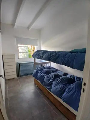 a bedroom with two bunk beds and a window at La casa de Clo in Villa Carlos Paz