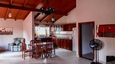 a kitchen and dining room with a table and chairs at Casa Villa del Lago in Villa Carlos Paz