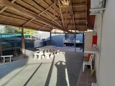 a group of benches sitting inside of a building at Casa Villa del Lago in Villa Carlos Paz