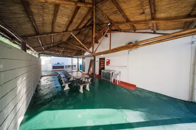 an indoor pool with a green floor in a building at Casa Villa del Lago in Villa Carlos Paz