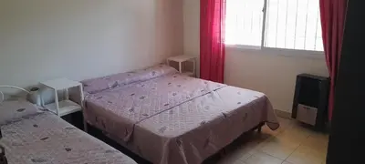 a small bedroom with two beds and a window at Casa Villa del Lago in Villa Carlos Paz