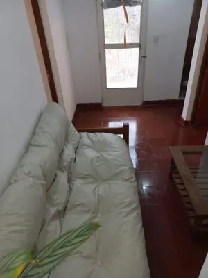 a white couch in a room with a window at Chalet Centrico in Merlo