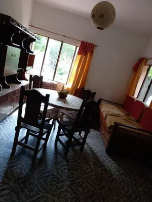 a living room with a table and chairs and a couch at Chalet Centrico in Merlo