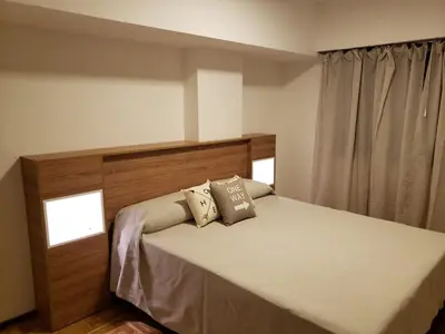 a bedroom with a bed with two pillows on it at Departamento de Antonia in Cordoba