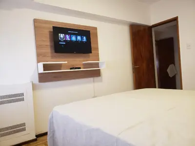 a bedroom with a bed and a flat screen tv at Departamento de Antonia in Cordoba