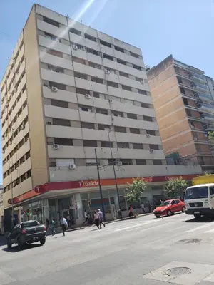 a large building with cars parked in front of it at Departamento de Antonia in Cordoba