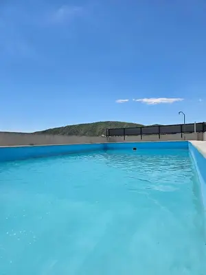 a swimming pool filled with blue water at Apartamento Esquiu H in Villa Carlos Paz