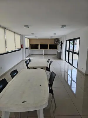 a room with two tables and chairs in a building at Apartamento Esquiu H in Villa Carlos Paz