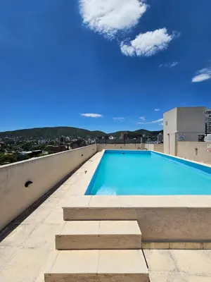 a swimming pool on the roof of a building at Apartamento Esquiu H in Villa Carlos Paz