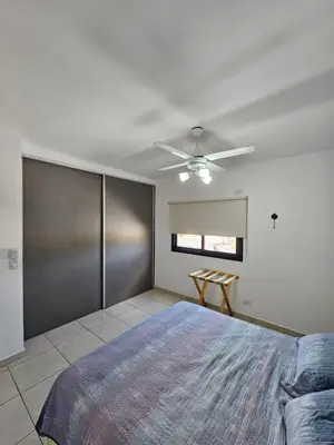 a bedroom with a bed and a ceiling fan at Apartamento Esquiu H in Villa Carlos Paz