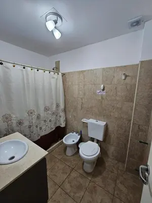 a bathroom with a toilet and a sink at Apartamento Esquiu C in Villa Carlos Paz