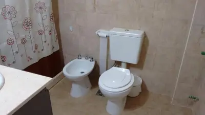 a bathroom with a toilet and a sink at Apartamento Esquiu C in Villa Carlos Paz