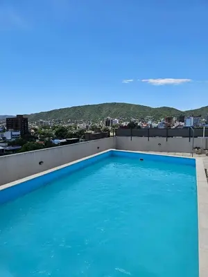 a swimming pool on the roof of a building at Apartamento Esquiu C in Villa Carlos Paz