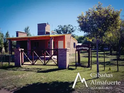 a small house with a sign in front of it at Cabañas Almafuerte in Villa Quillinzo