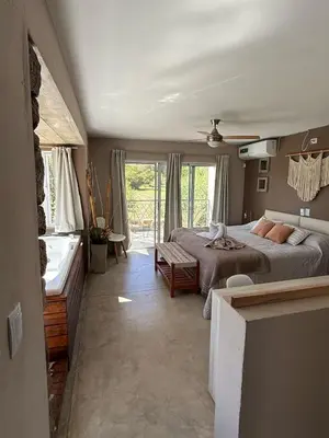 a bedroom with a large bed and a window at SOLSALI Cabaña moderna in San Javier