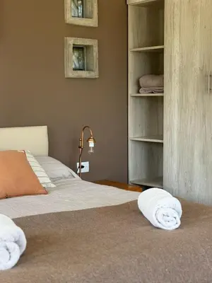 a bedroom with a bed with towels on it at SOLSALI Cabaña moderna in San Javier