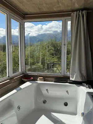 a white bath tub in a bathroom with a window at SOLSALI Cabaña moderna in San Javier