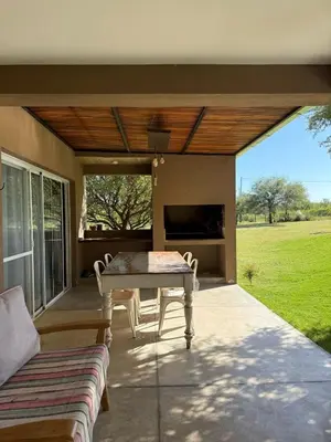 a patio with a table and chairs on a porch at SOLSALI Cabaña moderna in San Javier