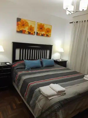 a bedroom with a large bed with two towels on it at Amplio y Centrico in Cordoba