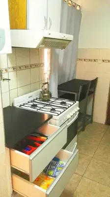 a kitchen with an oven with a pot on top at Amplio y Centrico in Cordoba