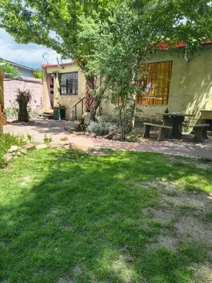 a house with a picnic table in the yard at La Casa De La Gruta in Mina Clavero