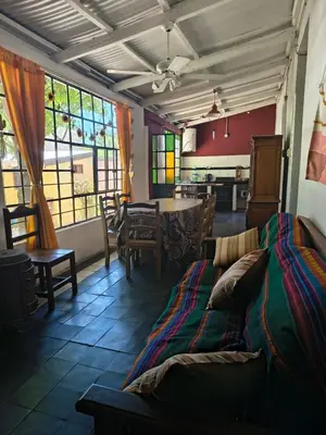 a living room with a bed and a table and chairs at La Casa De La Gruta in Mina Clavero