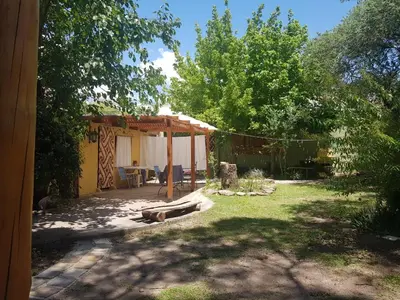 a yard with a house with a tent at La Casa De La Gruta in Mina Clavero