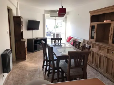 a kitchen with a dining room table and chairs at Departamento Alberdi Completo con Cochera in Cordoba