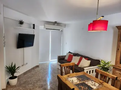 a living room with a couch and a table at Departamento Alberdi Completo con Cochera in Cordoba