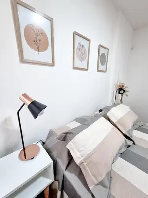 a bedroom with a bed and a desk with a lamp at DPTO 3 CUADRAS SANATORIO ALLENDE - NVA CBA in Cordoba