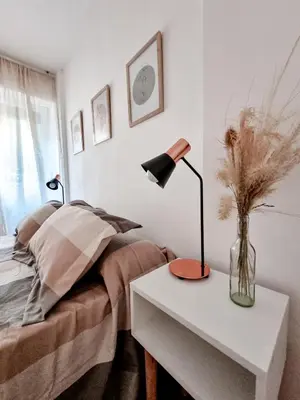 a bedroom with a bed and a table with a lamp at DPTO 3 CUADRAS SANATORIO ALLENDE - NVA CBA in Cordoba