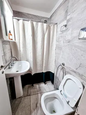 a bathroom with a sink and a toilet and a shower at DPTO 3 CUADRAS SANATORIO ALLENDE - NVA CBA in Cordoba