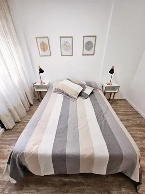a bedroom with a large bed with two night stands at DPTO 3 CUADRAS SANATORIO ALLENDE - NVA CBA in Cordoba