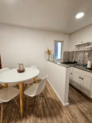a kitchen with a table and chairs in a room at DPTO 3 CUADRAS SANATORIO ALLENDE - NVA CBA in Cordoba