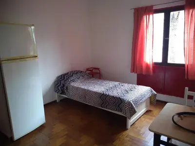 a bedroom with a bed in a room with a window at Departamento Alberdi Little in Cordoba