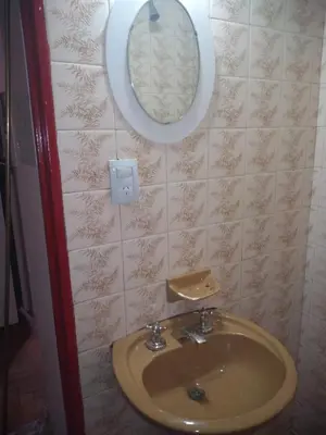a bathroom with a sink and a mirror on the wall at Departamento Alberdi Little in Cordoba