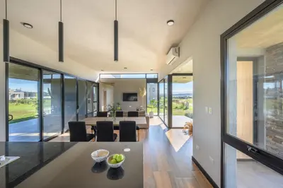 a dining room and living room with sliding glass doors at Casa Puerto del Aguila - Potrero de Garay in Potrero de Garay
