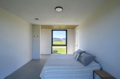 a bedroom with a large bed with a large window at Casa Puerto del Aguila - Potrero de Garay in Potrero de Garay
