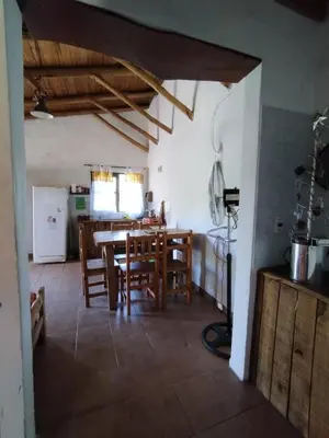 a kitchen and dining room with a table and chairs at Cabañas de montaña 