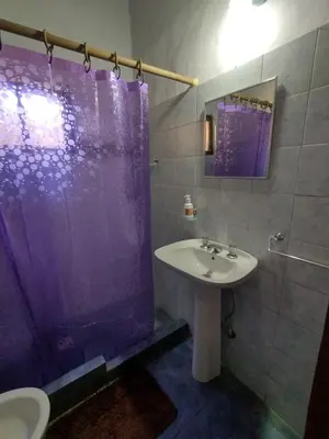 a bathroom with a sink and a shower and a toilet at Cabañas de montaña 