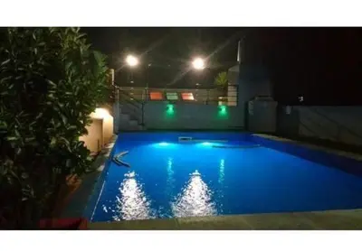 a large blue swimming pool at night with lights at Los Ceibos dpto para 4 personas in Estancia Vieja